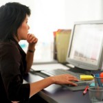 Woman reading computer monitor