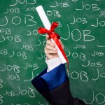 Hand holding a diploma in front of word Job