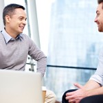 Two men talking in office