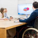 man in wheelchair at business meeting