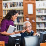 People working on computers in library