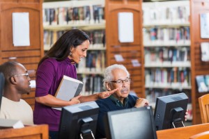 People working on computers in library