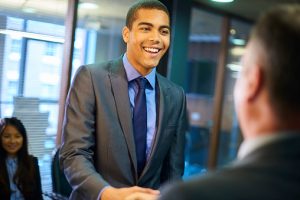 Confident employee shaking hands