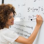 Female math student at whiteboard