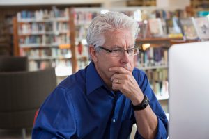 Man using computer to do career research.