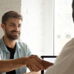 men shaking hands across a table