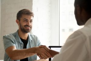 men shaking hands across a table