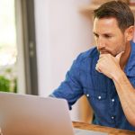 man working on his laptop at home