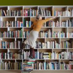 librarian standing on books