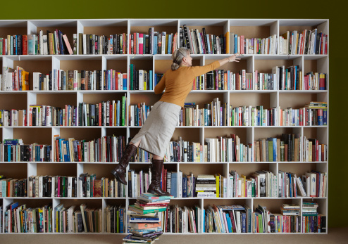 librarian standing on books 