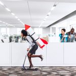 Woman speeding thru the office on the scooter with a rocket strapped to her back while her happy multiethnic co-workers are watching her succeed in the workplace