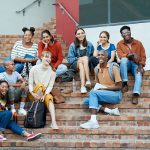 diverse college students gather on steps