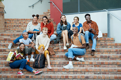 diverse college students gather on steps