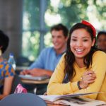 Happy high school student in classroom