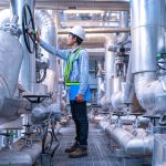 Engineer working at industrial zone for operate equipment, Steel pipelines and valve