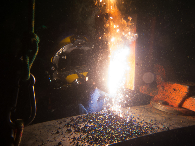 Underwater welder working on equipment