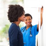 African American physician assistant measuring a patient's height