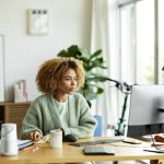 Businesswoman Using Computer At Home Office