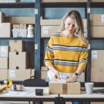 Woman packaging items at a small business